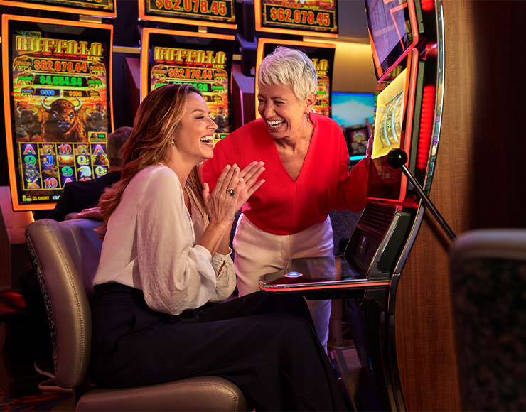 couple of friends playing slots