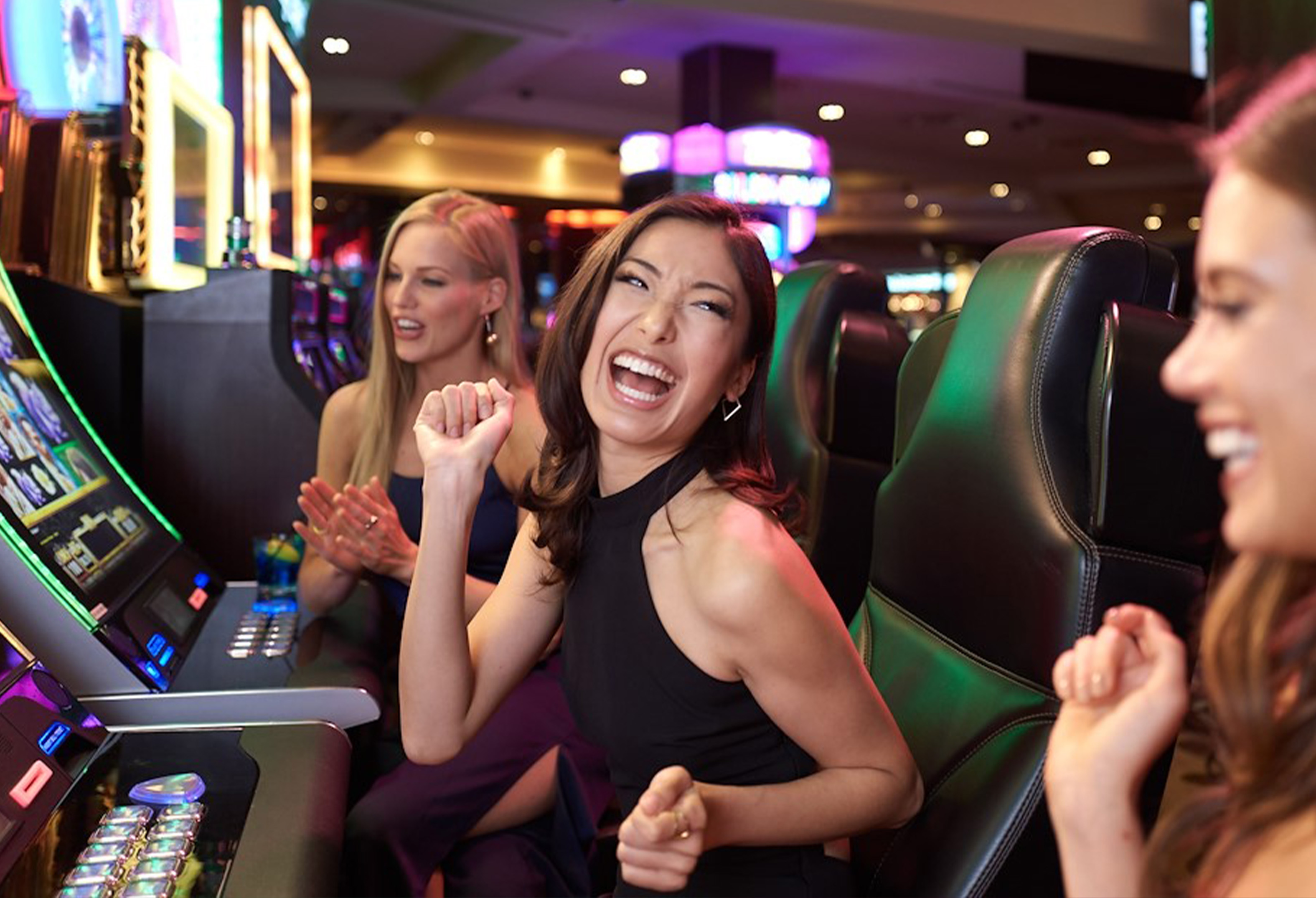 Casino Development: women cheering at slot machines