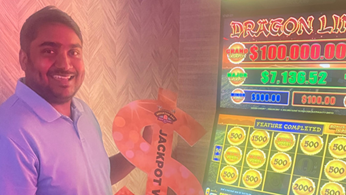 Ankit Jaiswal beside his $135k Dragon Link Jackpot