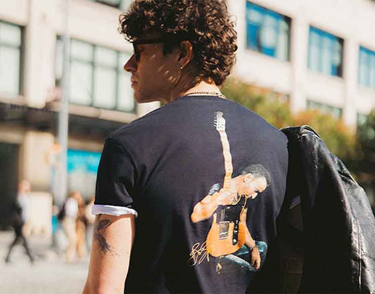 Man wearing an artist collection tee.