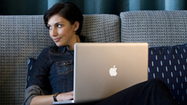 Woman on Sofa with Laptop