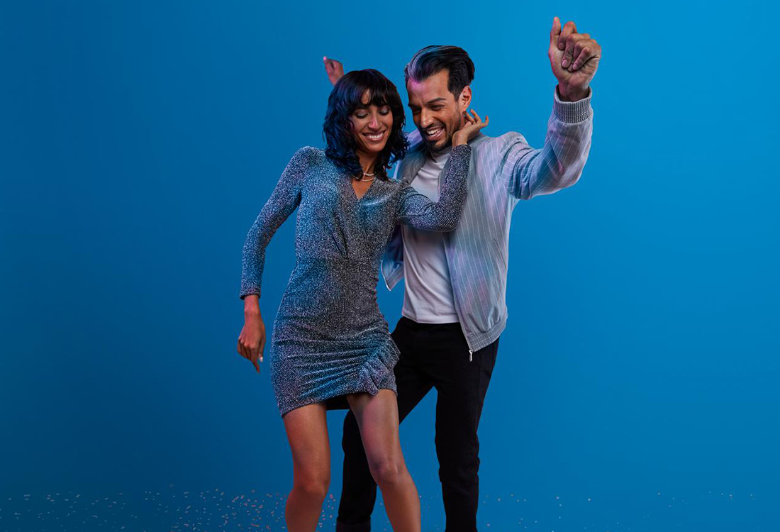 a couple dancing on a blue background