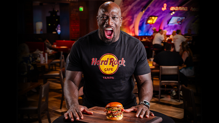 Thaddeus Bullard wearing Hard Rock Cafe shirt with Seminole Hard Rock Tampa's Clash of the Titus Burger